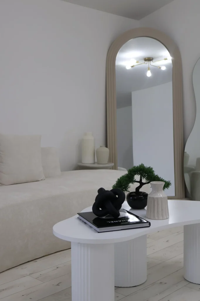 Natural-light content studio set with cream sofa and sculptural furniture