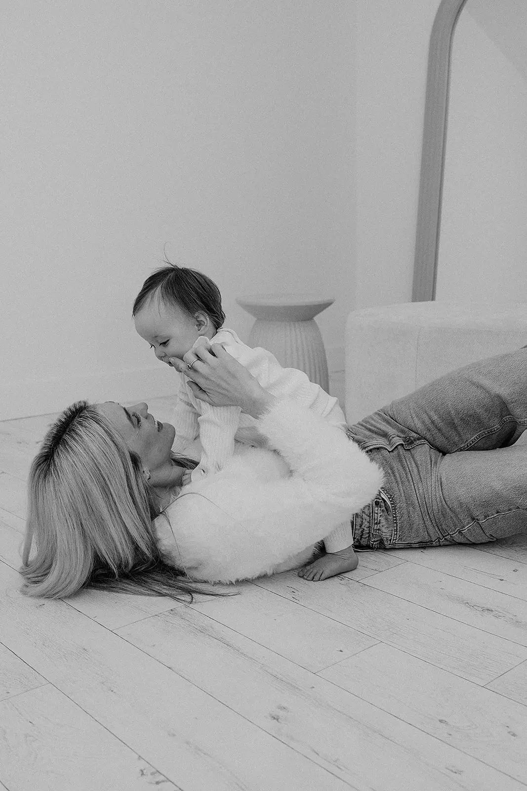 Mother cuddling her baby in a natural-light family photography studio near Coventry
