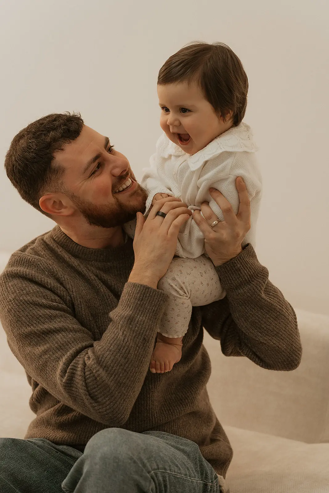 Father holding his baby during a family studio portrait session