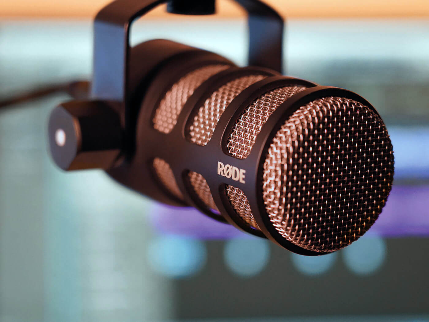 Promotional close-up of the black and silver RØDE PodMic XLR microphone