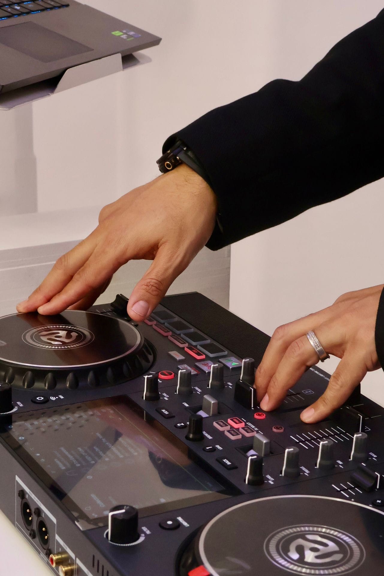 Creative close-up of hands using DJ decks in the studio