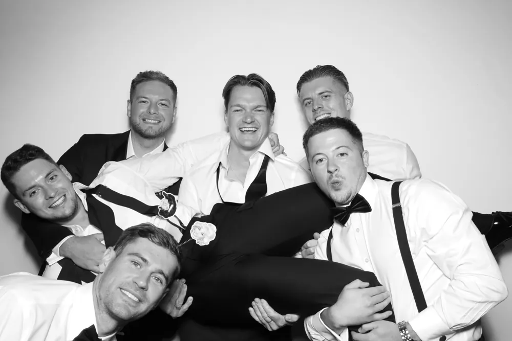 Groomsmen celebrating together in the Glam Booth