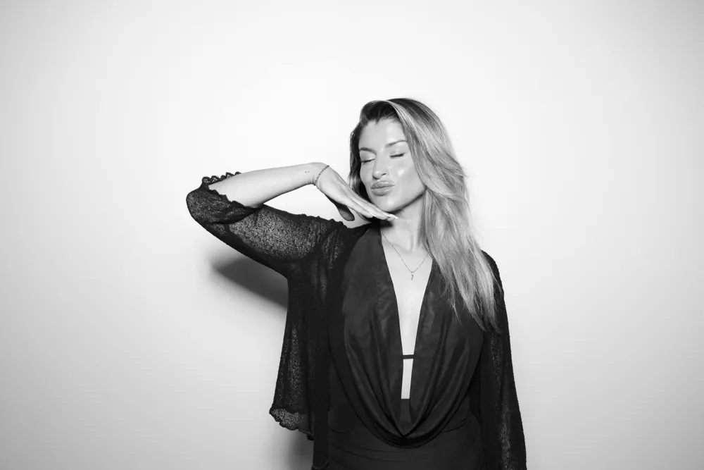A guest posing for a monochrome Glam Booth portrait