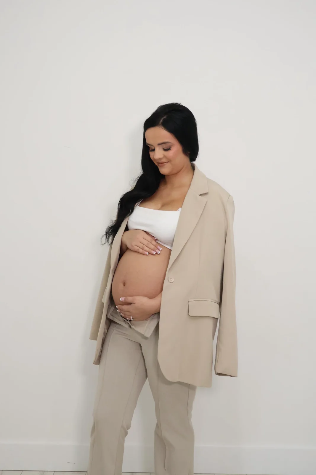 Maternity portrait in a neutral suit at Selfie Studios