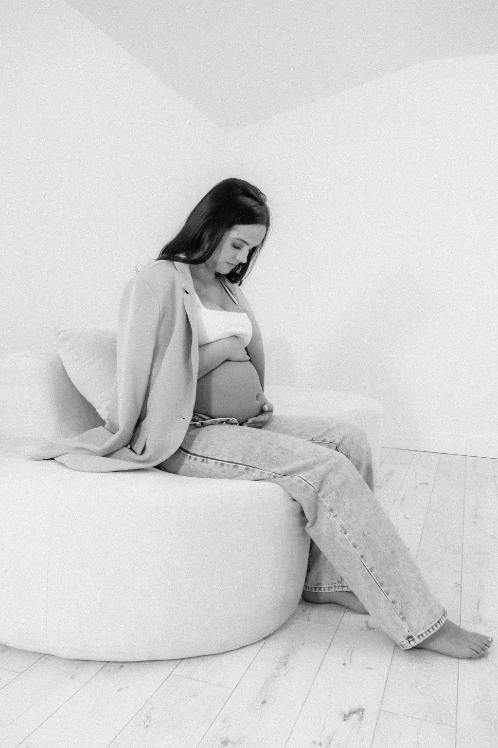 Black-and-white maternity portrait using the studio sofa