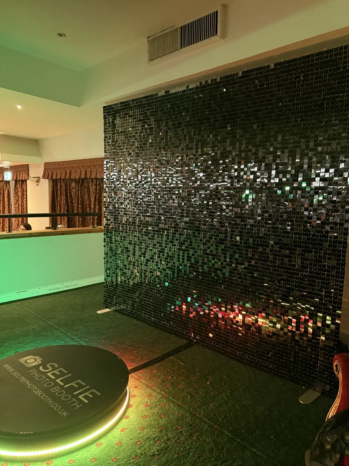 Black shimmer sequin wall photographed at an event