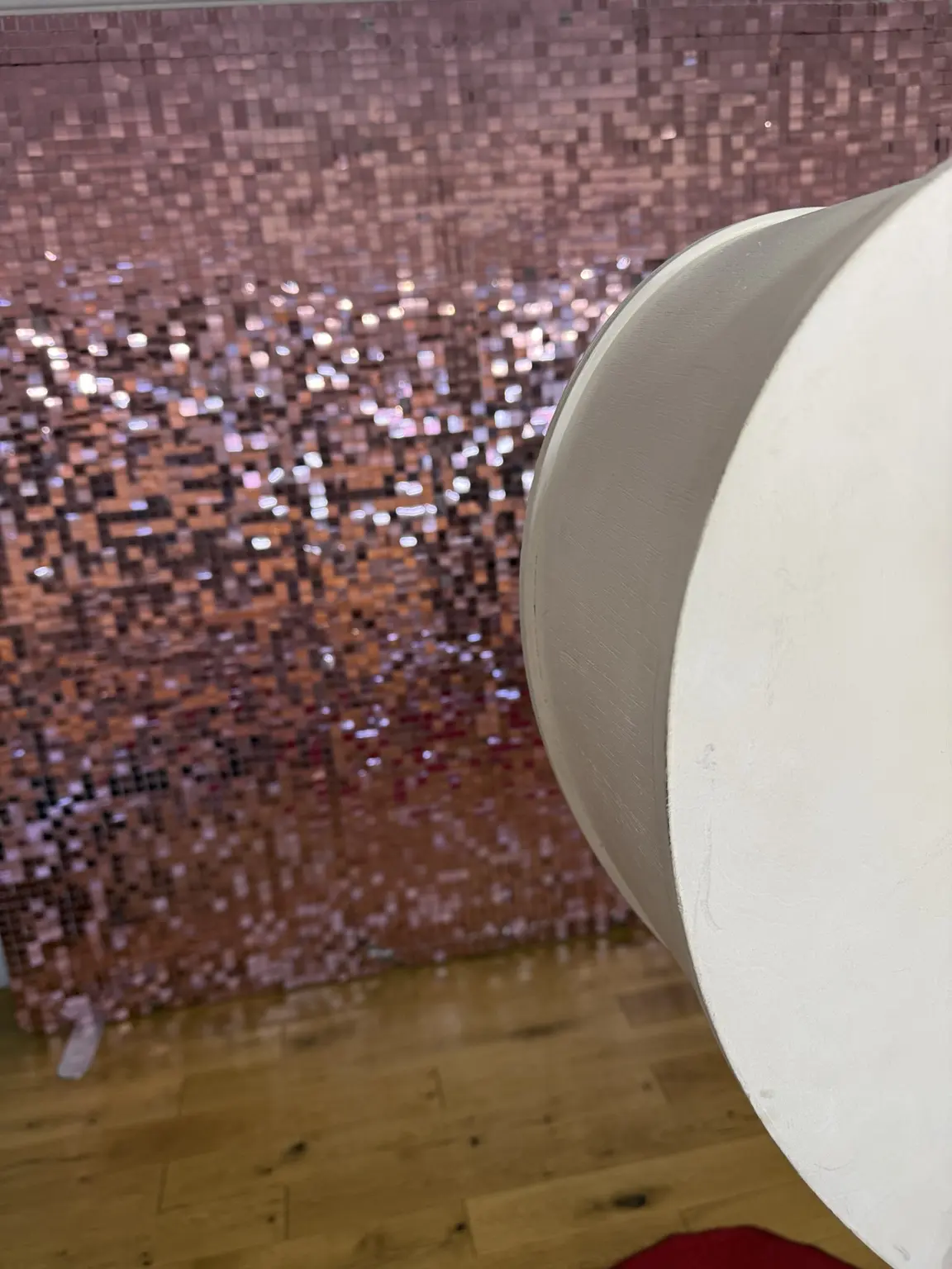 Pink shimmer sequin wall photographed at an event