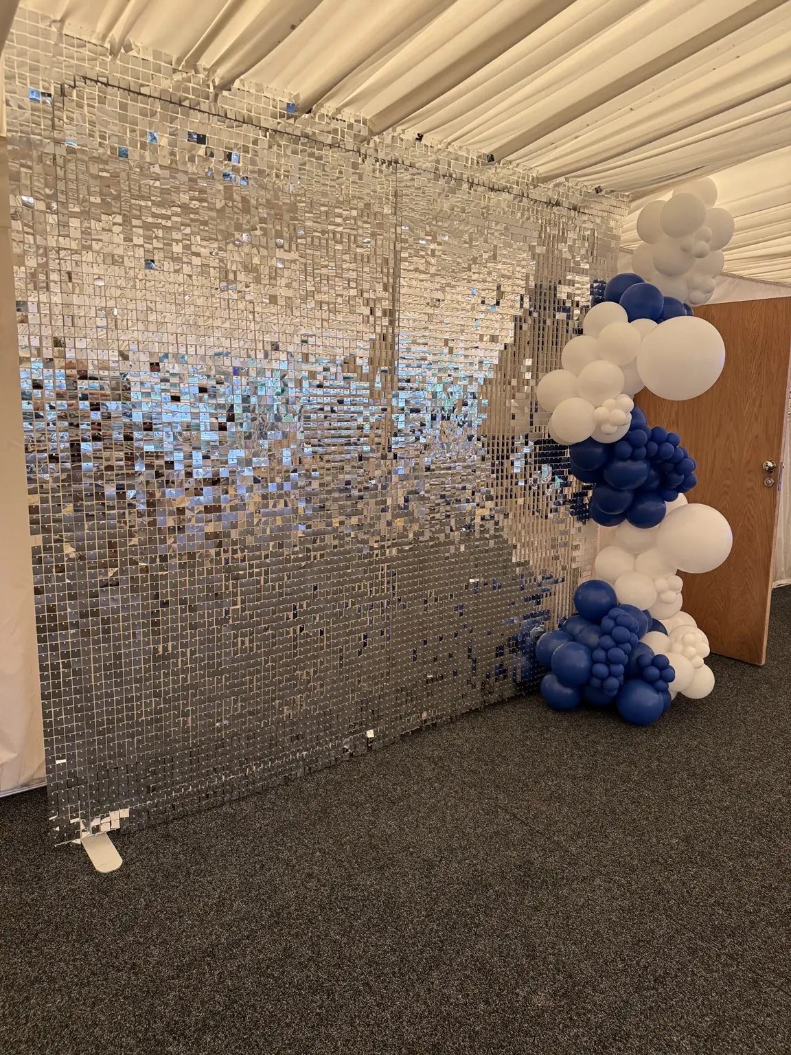 Silver shimmer sequin wall photographed at an event